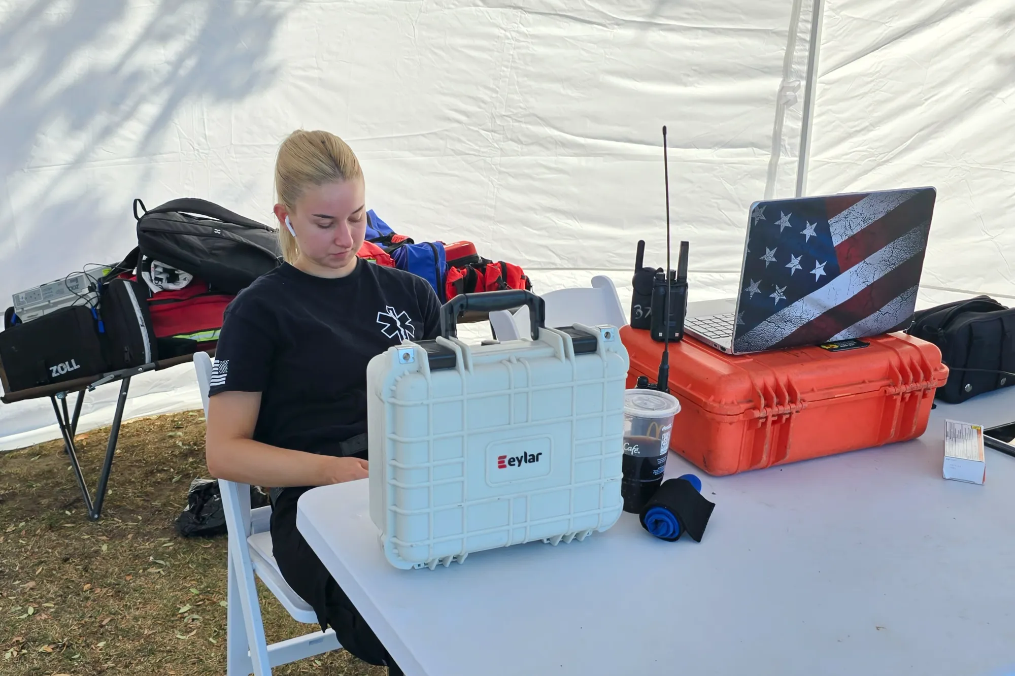 A woman paramedic staffing a medical tent.